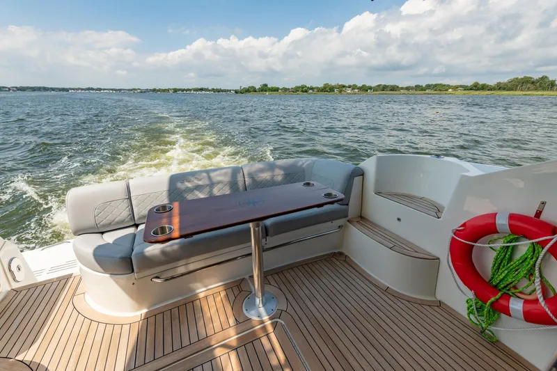 Slide: The Image of Luxurious 2017 Sea Ray Fly 510 yacht deck with seating and scenic water view. - 23