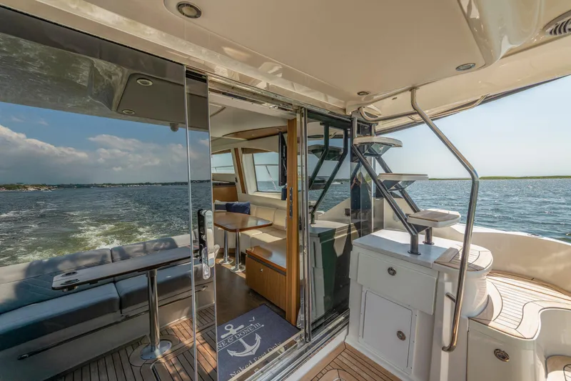 Slide: The Image of Luxurious 2017 Sea Ray Fly 510 yacht interior with ocean view and elegant seating area. - 26