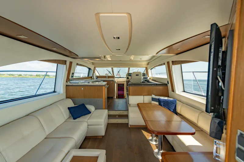Slide: The Image of Luxurious interior of 2017 Sea Ray Fly 510 yacht with elegant seating and panoramic windows. - 27