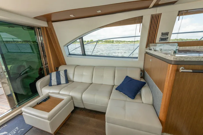 Slide: The Image of Luxurious interior of 2017 Sea Ray Fly 510 yacht with plush seating and scenic window view. - 28