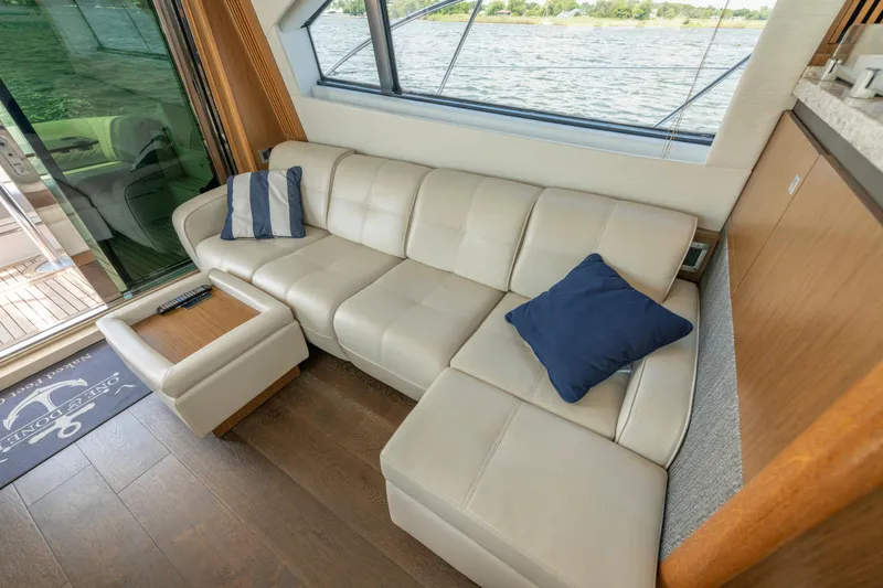 Slide: The Image of Luxurious interior of 2017 Sea Ray Fly 510 yacht with cream leather sofa and blue cushions. - 29