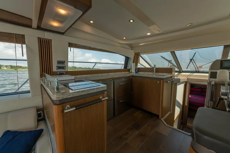 Slide: The Image of Luxurious interior of 2017 Sea Ray Fly 510 yacht with modern kitchen and scenic windows. - 34