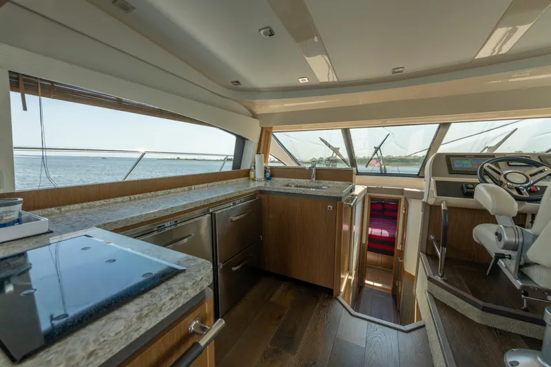 Slide: The Image of Luxurious interior of 2017 Sea Ray Fly 510 yacht with modern kitchen and helm. - 35