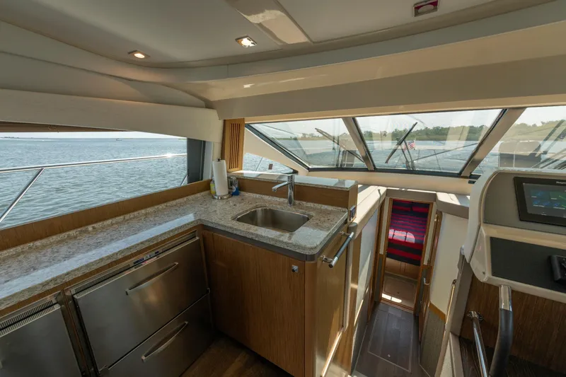 Slide: The Image of Luxurious 2017 Sea Ray Fly 510 yacht interior with modern kitchen and scenic water view. - 36