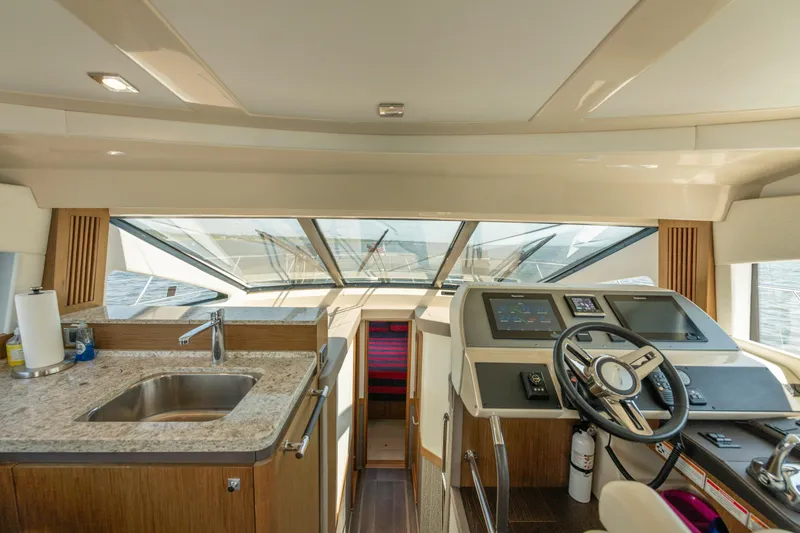 Slide: The Image of Interior of 2017 Sea Ray Fly 510 yacht with helm and kitchenette. - 41