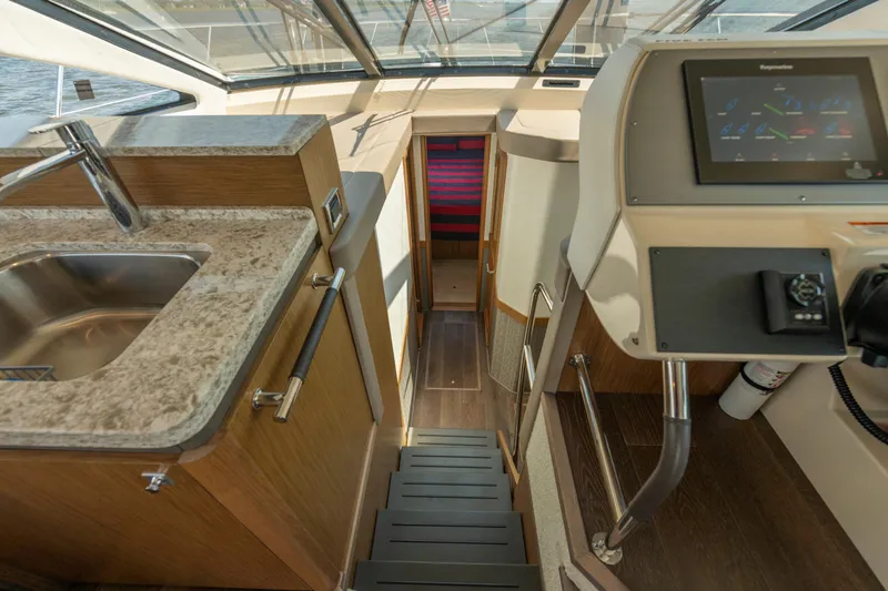 Slide: The Image of Interior view of 2017 Sea Ray Fly 510 yacht with modern kitchen and navigation panel. - 42