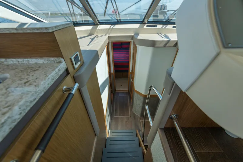 Slide: The Image of Interior view of 2017 Sea Ray Fly 510 yacht, featuring modern design and wooden finishes. - 44