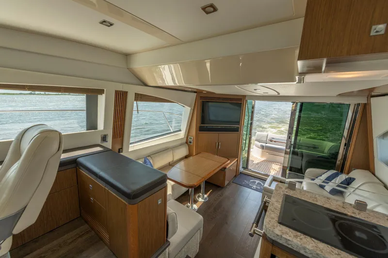 Slide: The Image of Luxurious interior of 2017 Sea Ray Fly 510 yacht with modern furnishings and scenic water view. - 46