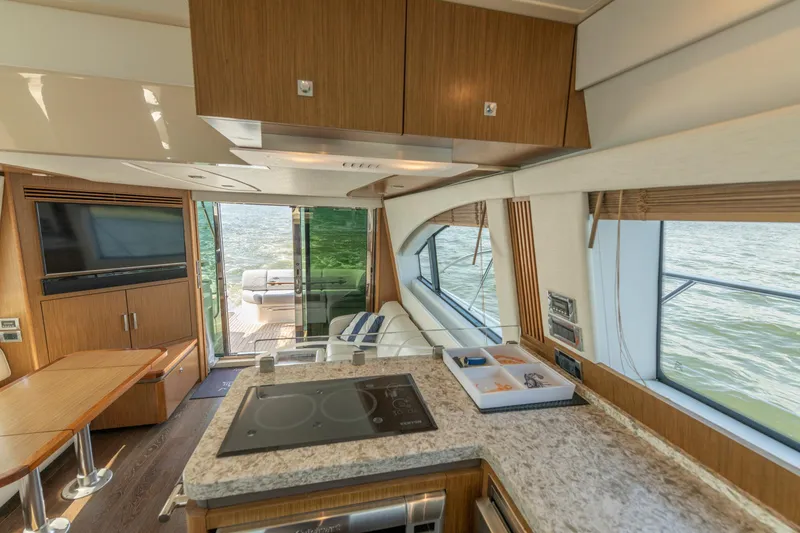 Slide: The Image of Luxurious interior of 2017 Sea Ray Fly 510 yacht with modern kitchen and scenic water view. - 47