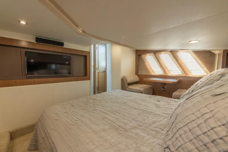 Slide: The Image of Luxurious interior of 2017 Sea Ray Fly 510 yacht with bed, TV, and seating area. - 51