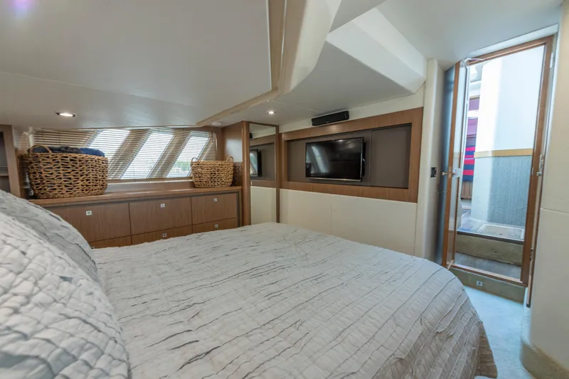 Slide: The Image of Luxurious 2017 Sea Ray Fly 510 yacht bedroom with modern decor and natural light. - 56