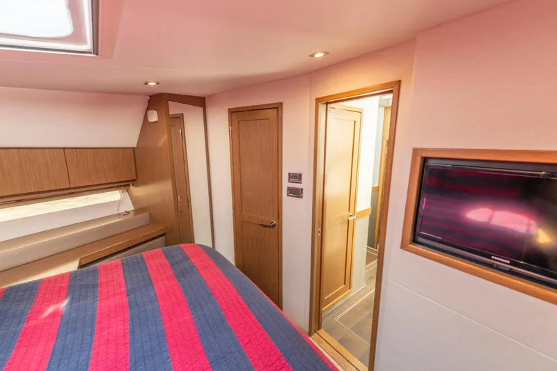 Slide: The Image of Luxurious 2017 Sea Ray Fly 510 yacht bedroom with modern wood finishes and TV. - 62