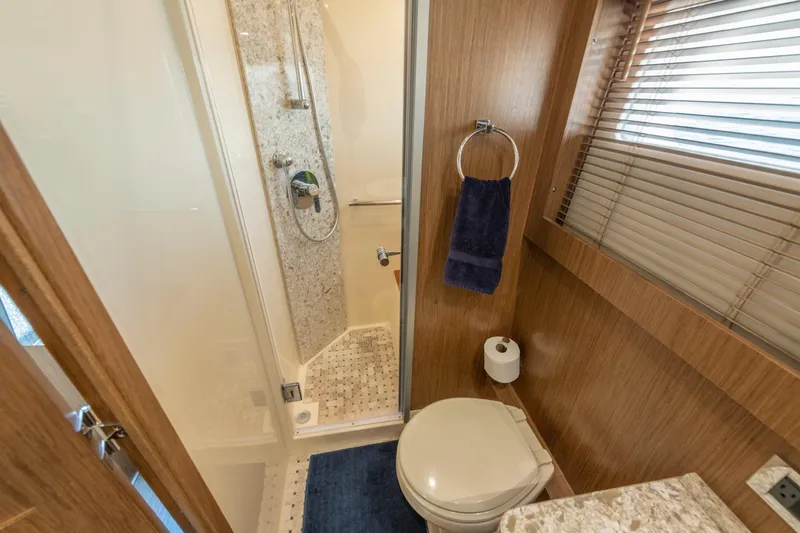 Slide: The Image of Luxurious bathroom in 2017 Sea Ray Fly 510 yacht with shower and wooden accents. - 68