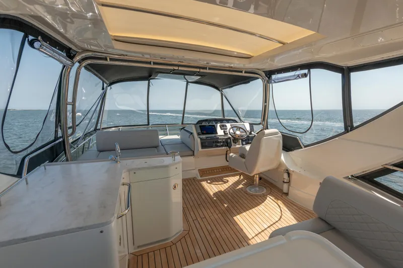 Slide: The Image of Luxurious 2017 Sea Ray Fly 510 yacht interior with ocean view and modern helm. - 70