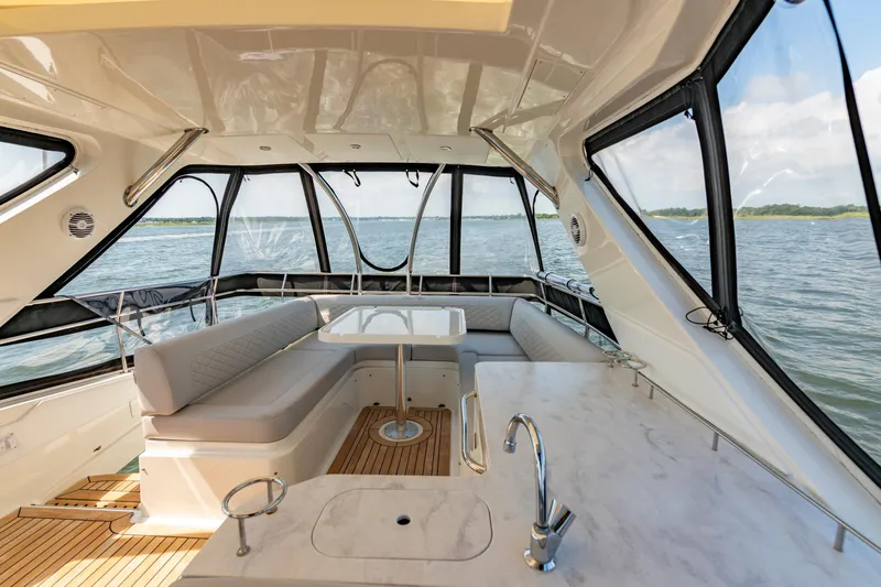 Slide: The Image of Luxurious interior of 2017 Sea Ray Fly 510 yacht with panoramic windows and elegant seating. - 72