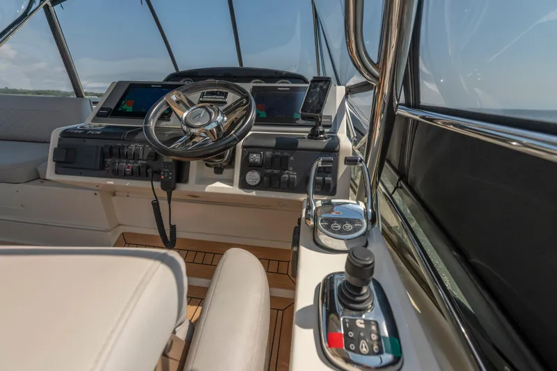 Slide: The Image of 2017 Sea Ray Fly 510 yacht cockpit with modern controls and steering wheel. - 78