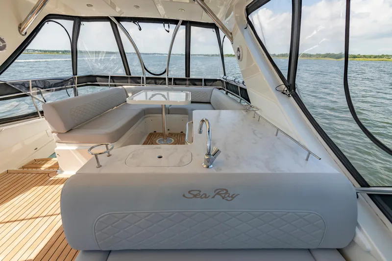 Slide: The Image of Luxurious interior of 2017 Sea Ray Fly 510 yacht with elegant seating and panoramic windows. - 79