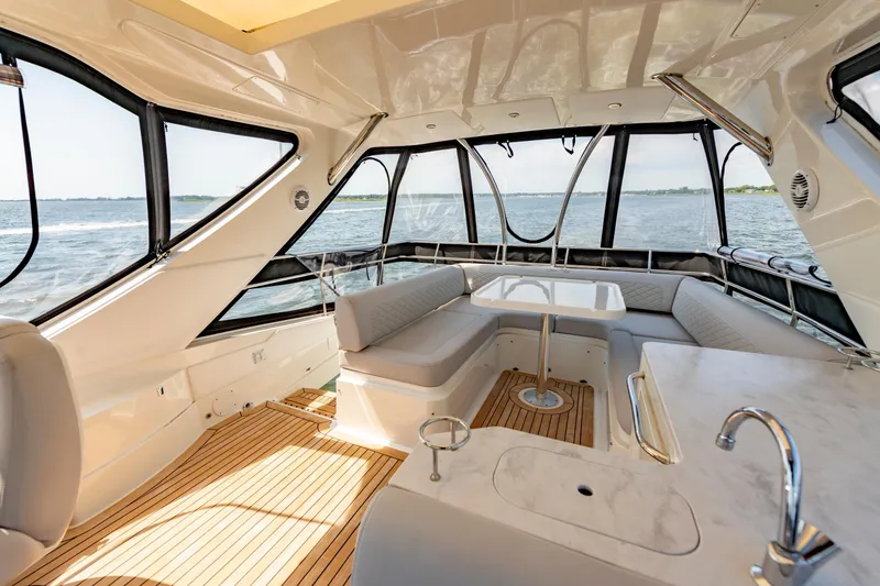 Slide: The Image of Luxurious interior of 2017 Sea Ray Fly 510 yacht with panoramic windows and elegant seating. - 80