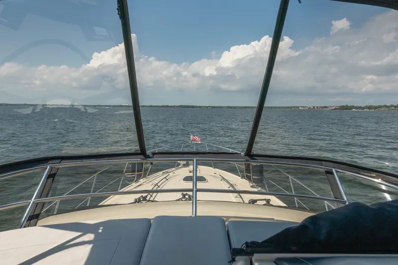 Slide: The Image of 2017 Sea Ray Fly 510 yacht cruising on open water under a clear sky. - 85