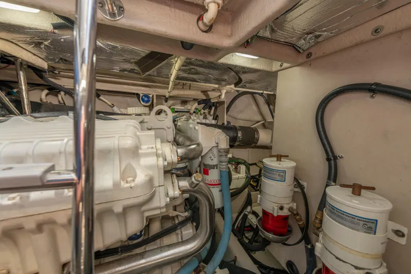 Slide: The Image of Engine room of 2017 Sea Ray Fly 510 yacht, showcasing mechanical components and filters. - 89