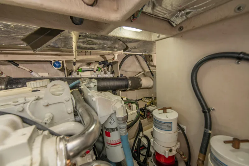 Slide: The Image of Engine room of 2017 Sea Ray Fly 510 yacht, showcasing mechanical components and piping. - 94