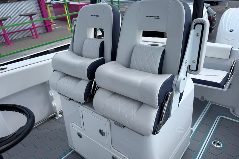 Slide: The Image of 2025 Stingray 253 CC boat interior with luxurious white seating and modern design. - 10