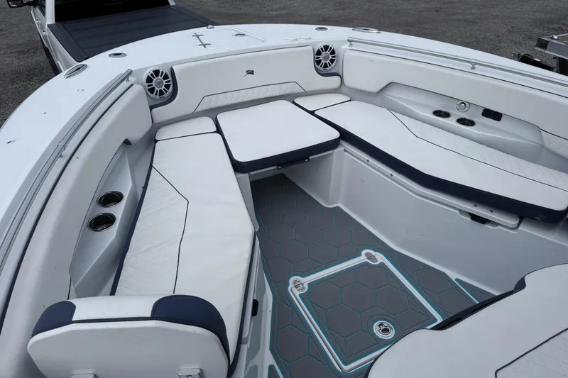 Slide: The Image of 2025 Stingray 253 CC boat interior with white seating and modern design. - 12
