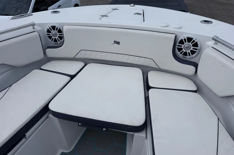 Slide: The Image of 2025 Stingray 253 CC boat interior with cushioned seating and built-in speakers. - 14