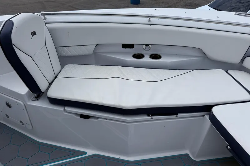 Slide: The Image of 2025 Stingray 253 CC boat interior with white cushioned seating and cup holders. - 15