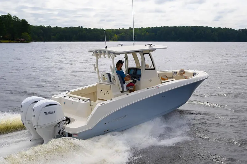 Slide: The Image of Manufacturer Provided Image: 2025 Stingray 253 CC boat cruising on a lake with dual Yamaha engines. - 16