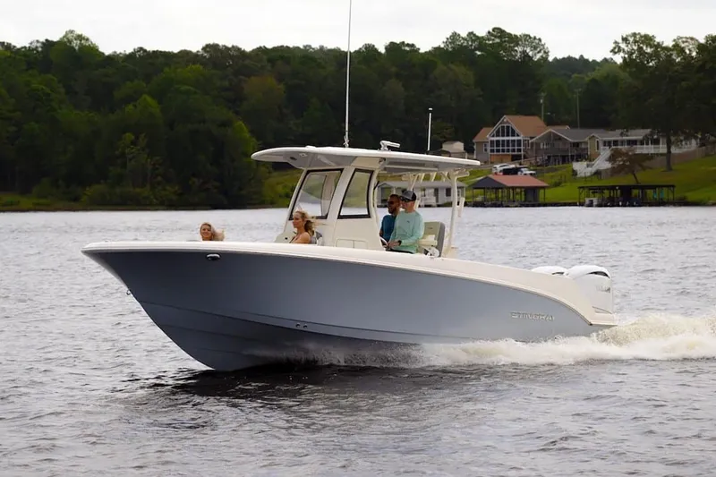 Slide: The Image of Manufacturer Provided Image: 2025 Stingray 253 CC boat cruising on a lake with passengers. - 17