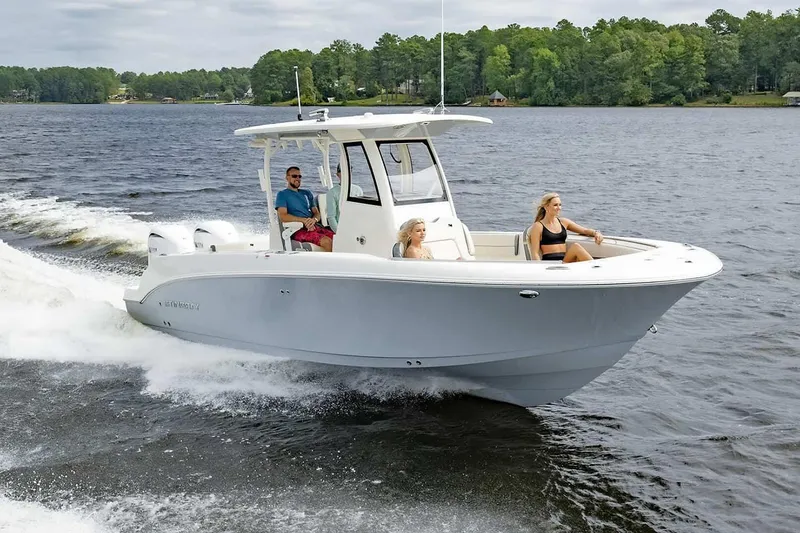 Slide: The Image of Manufacturer Provided Image: 2025 Stingray 253 CC boat cruising on a lake with three passengers. - 18