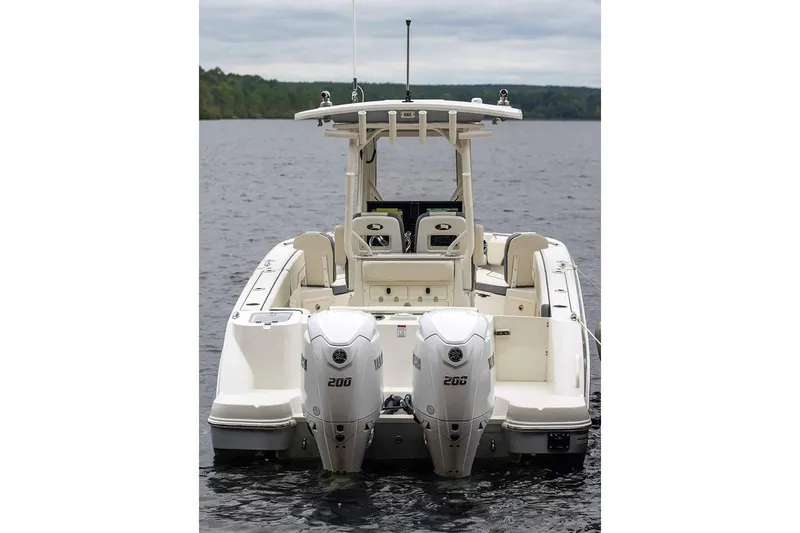 Slide: The Image of Manufacturer Provided Image: 2025 Stingray 253 CC boat with dual engines on a calm lake. - 19