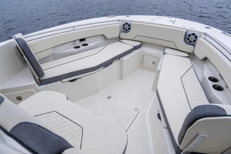 Slide: The Image of Manufacturer Provided Image: 2025 Stingray 253 CC boat interior with cushioned seating and cup holders. - 21