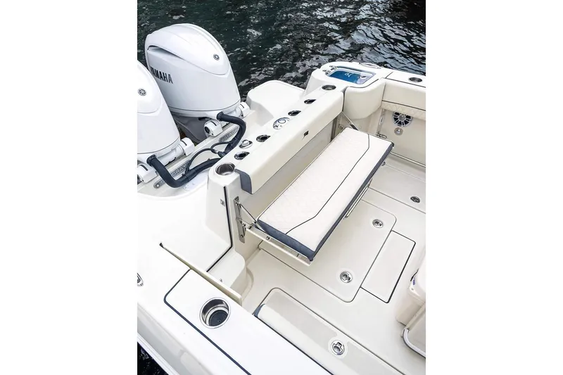 Slide: The Image of Manufacturer Provided Image: 2025 Stingray 253 CC boat interior with Yamaha engines, featuring a foldable seat and storage. - 25