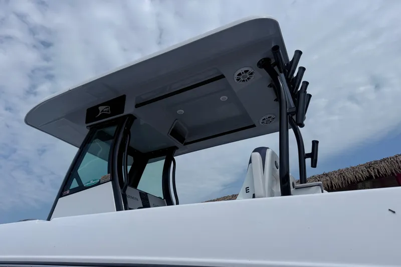Slide: The Image of 2025 Stingray 253 CC boat with T-top and rod holders against cloudy sky. - 4