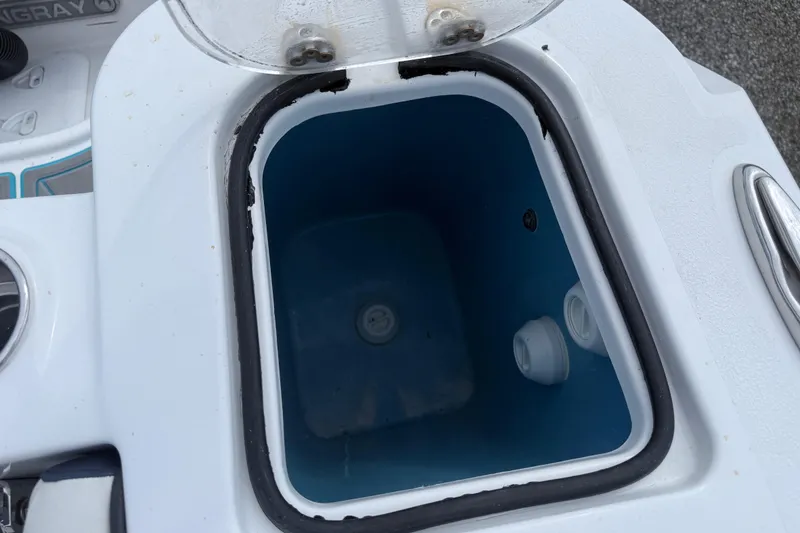Slide: The Image of Open storage compartment on 2025 Stingray 253 CC boat, featuring a blue interior. - 7