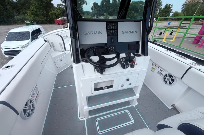 Slide: The Image of 2025 Stingray 253 CC boat cockpit with Garmin navigation system and modern controls. - 9