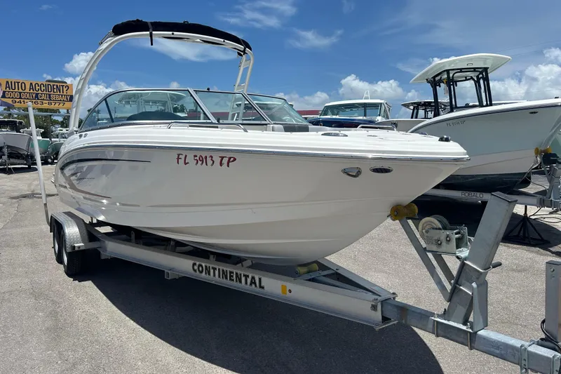 Slide: The Image of 2023 Chaparral 23 SSi OB boat on trailer in sunny outdoor setting. - 0