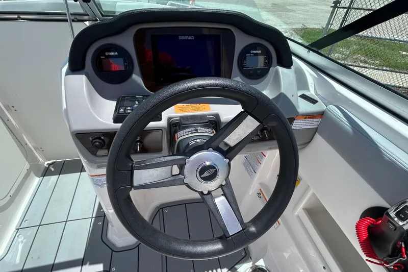 Slide: The Image of 2023 Chaparral 23 SSi OB boat dashboard with steering wheel and controls. - 10