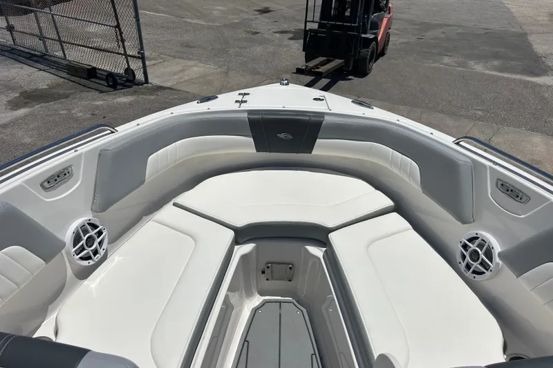 Slide: The Image of 2023 Chaparral 23 SSi OB boat interior with white seating and speakers. - 16