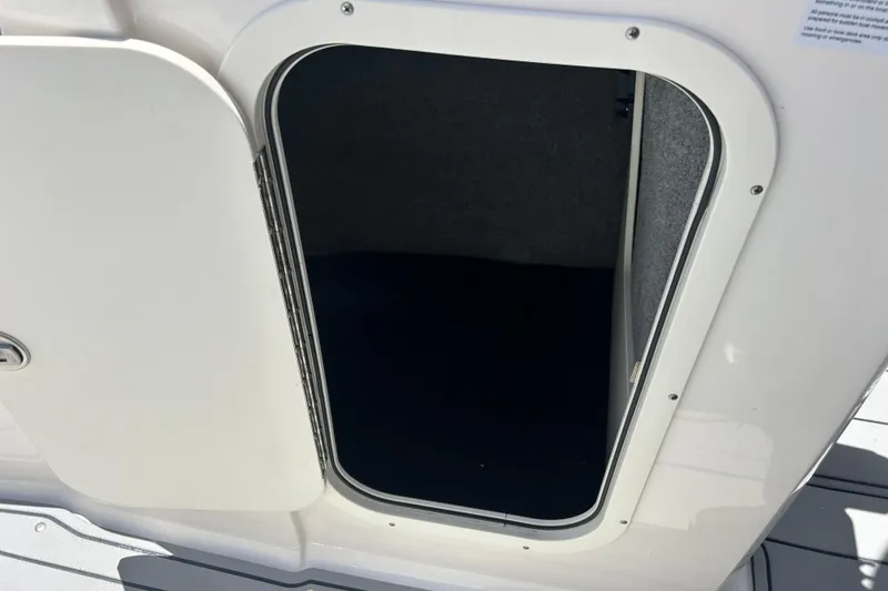 Slide: The Image of Open storage compartment on 2023 Chaparral 23 SSi OB boat. - 17