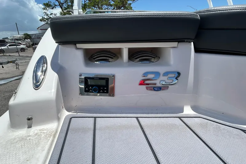 Slide: The Image of 2023 Chaparral 23 SSi OB boat interior with audio system and model emblem. - 18