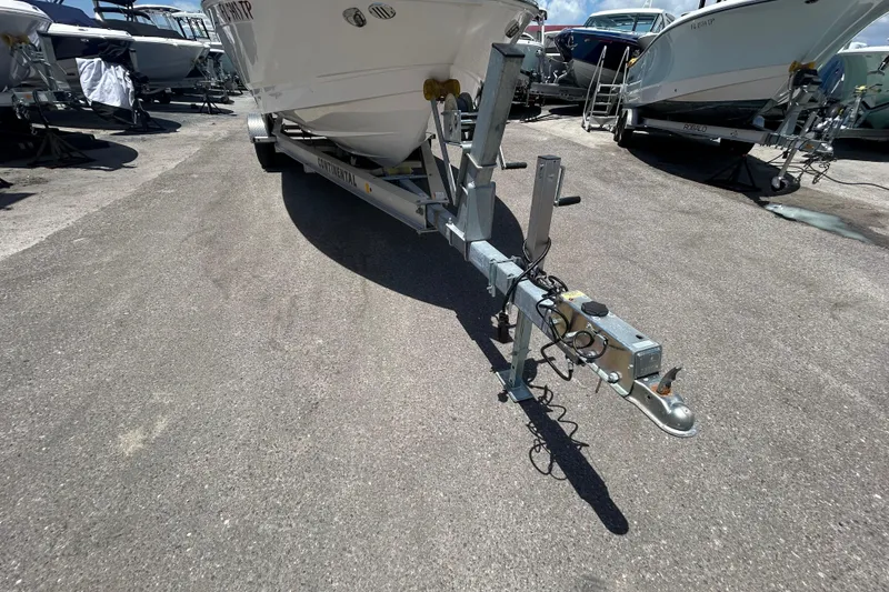 Slide: The Image of 2023 Chaparral 23 SSi OB boat on trailer in a marina setting. - 19