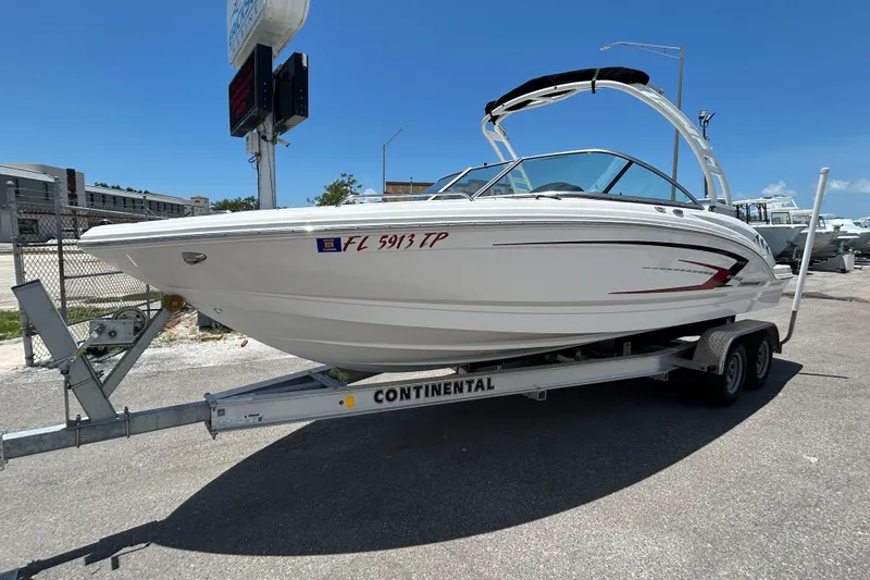 Slide: The Image of 2023 Chaparral 23 SSi OB boat on trailer under a cloudy sky. - 2