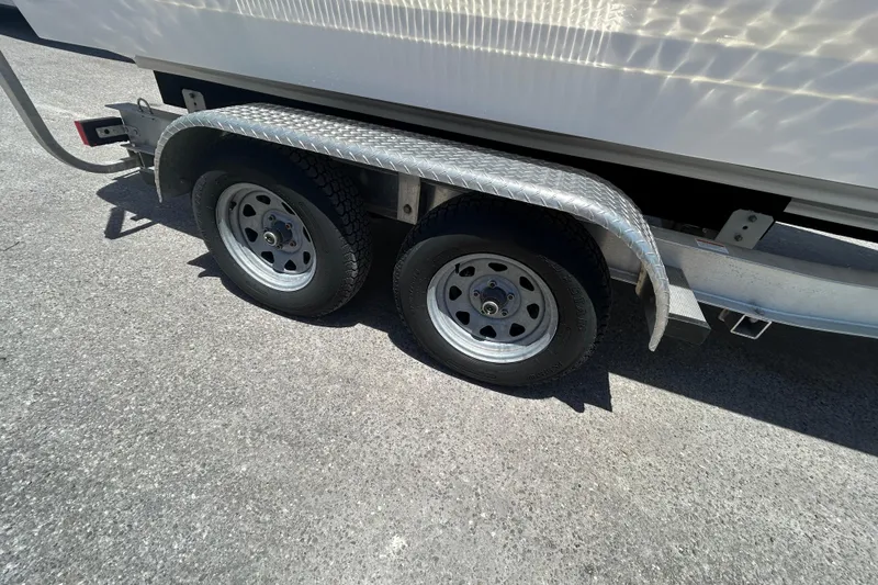 Slide: The Image of Trailer wheels of 2023 Chaparral 23 SSi OB boat on pavement. - 20