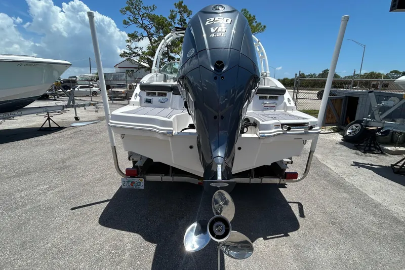 Slide: The Image of 2023 Chaparral 23 SSi OB boat with powerful V8 engine, parked outdoors. - 5