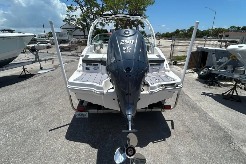 Slide: The Image of 2023 Chaparral 23 SSi OB boat with Yamaha 250 V6 engine, parked outdoors. - 6
