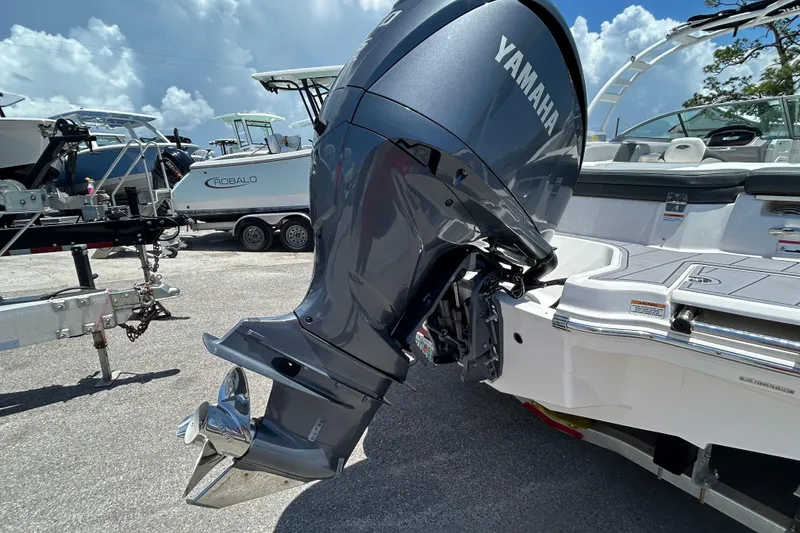 Slide: The Image of 2023 Chaparral 23 SSi OB with Yamaha outboard motor, parked on a sunny day. - 7