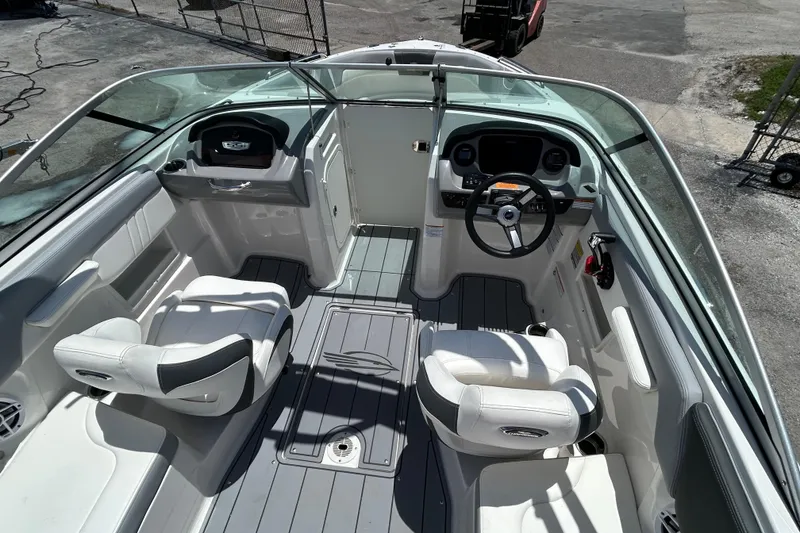 Slide: The Image of 2023 Chaparral 23 SSi OB boat interior with steering wheel and seating. - 9